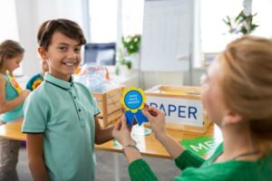 Reward and Motivate School Student holding a trophy and medals