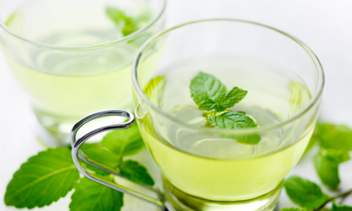 Mint tea in a glass cup with leaves