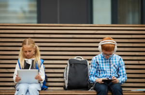 two school children using technology at school