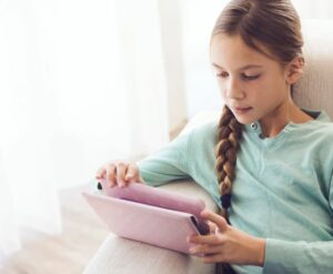 Child playing with tablet.