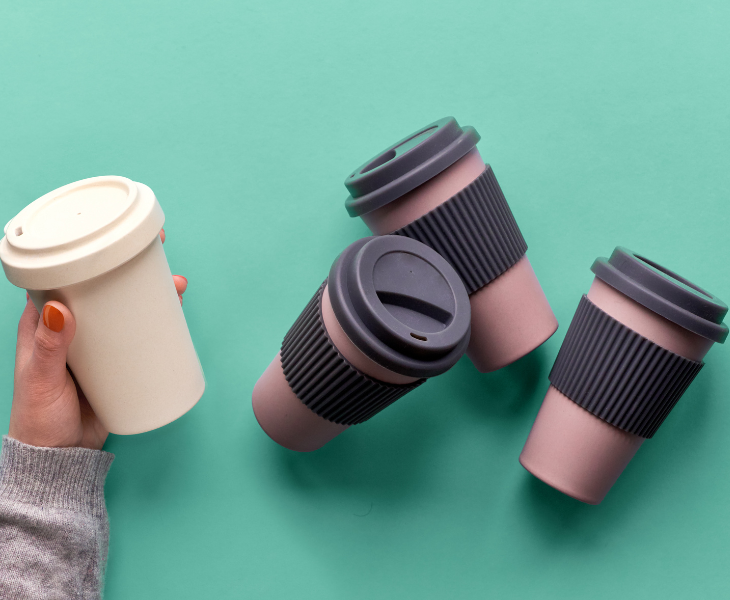 Girl holding reusable coffee cup