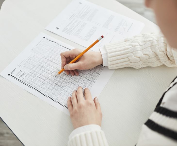 A student filling out a test paper.