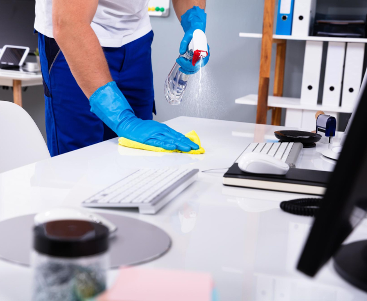 Man cleaning a keyboard with cleaning spray