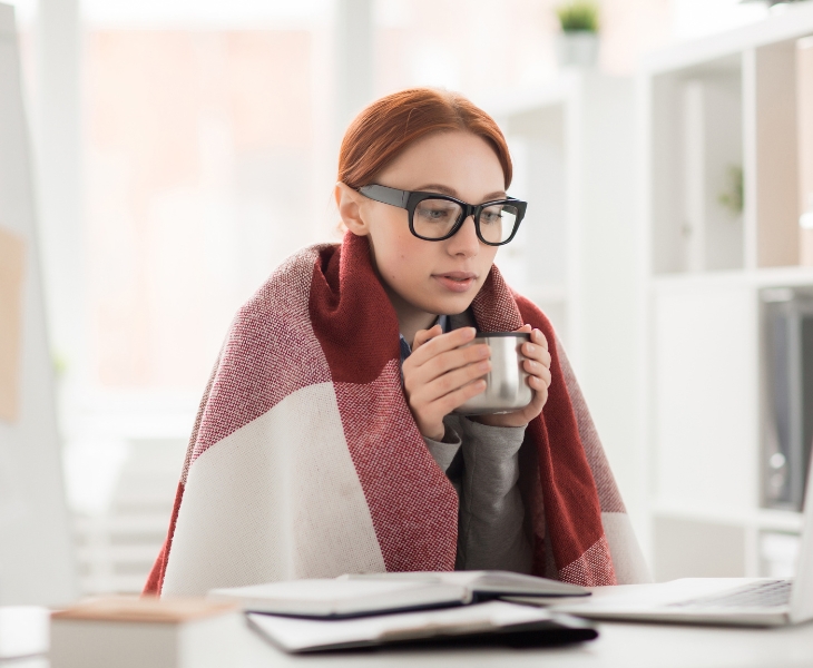 Girl sitting with coffee in office.