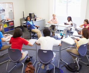 High school students with their devices in class