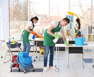 People thoroughly cleaning workplace