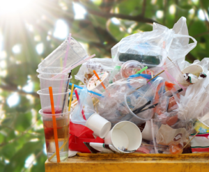 Waste bin with garbage and plastic bag waste